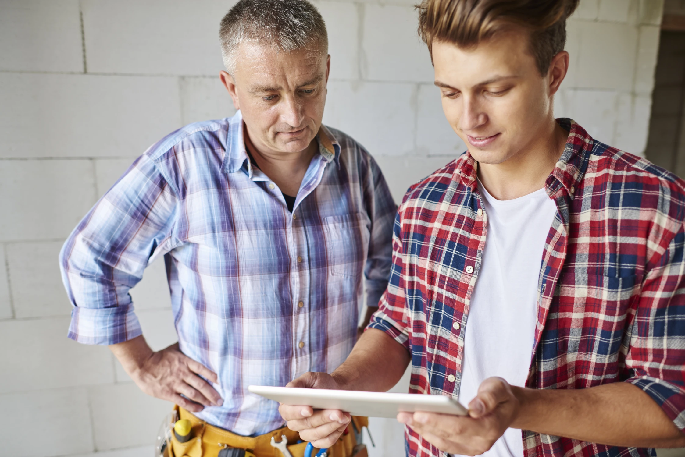 close-up-experienced-carpenter-his-younger-employee